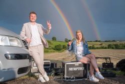 festival wedding bride groom with double rainbow sat on bands box